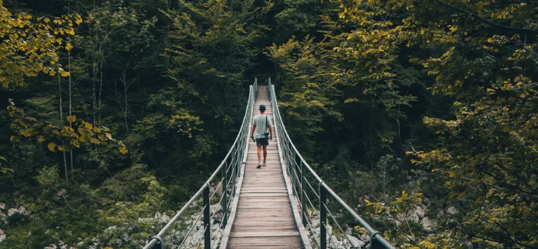 A man crosses a bridge